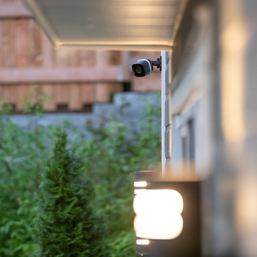 Black cctv surveillance camera outside building, home security system